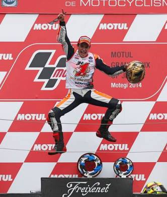 Honda MotoGP rider Marc Marquez of Spain jumps into the air on the podium after he finished in second place to become the 2014 world champion at the Japanese Grand Prix at the Twin Ring Motegi circuit in Motegi